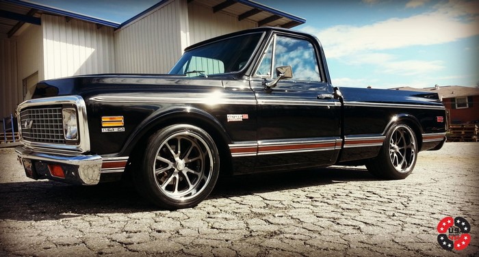 Black Chevrolet C10 pickup truck with custom wheels
