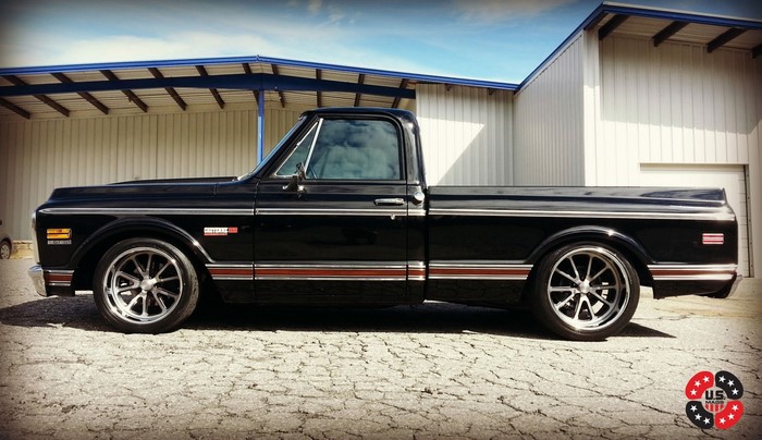Black Chevrolet C10 pickup truck with custom wheels
