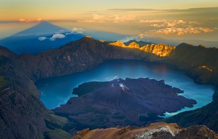 Mount Rinjani crater lake at sunrise with shadow