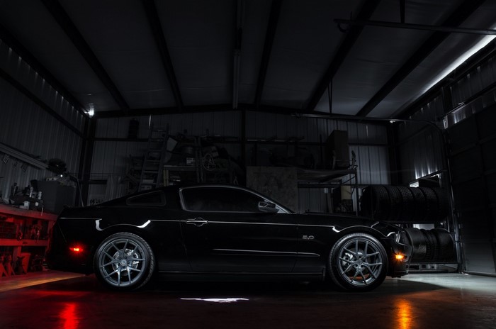 Black Ford Mustang GT parked in a garage