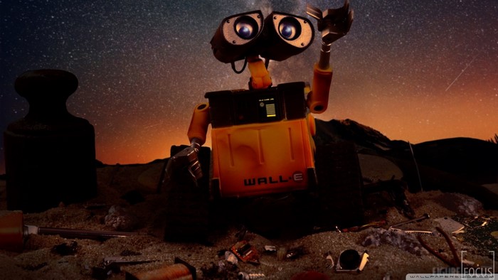 WALL-E robot on a trash-filled planet at night