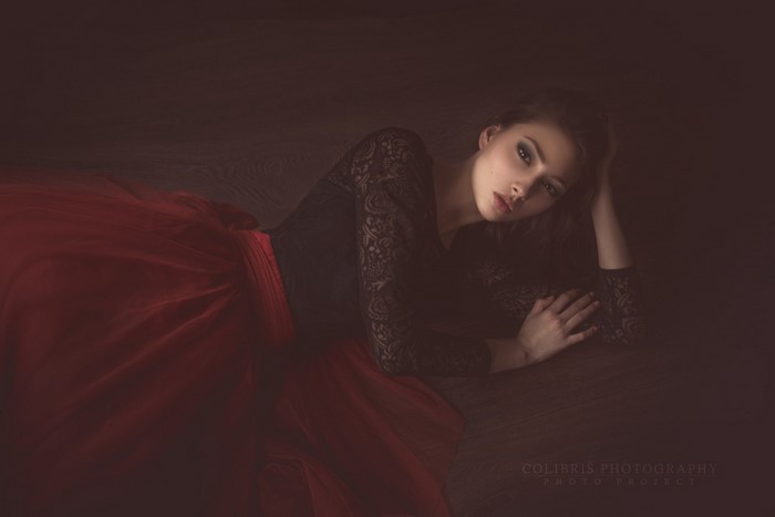 Woman in red dress lying on floor