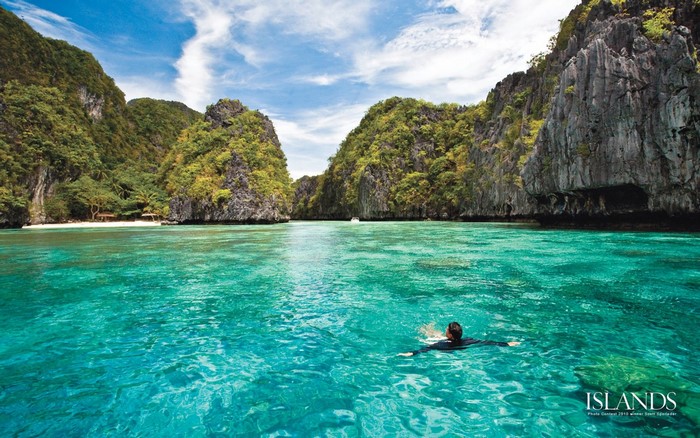 Person swimming in a tropical island lagoon