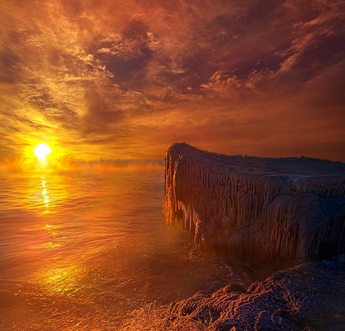 Frozen coast at sunrise with dramatic sky