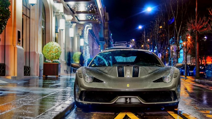 Ferrari 458 Speciale parked on a wet street at night