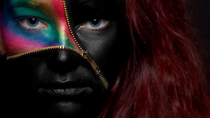 Woman with colorful body paint and zipper
