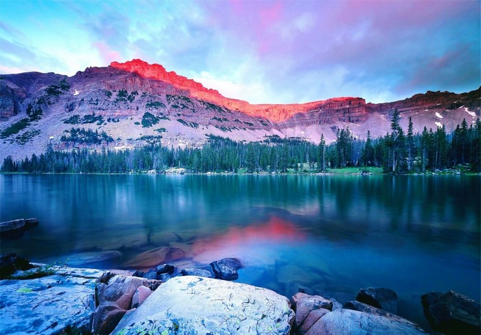 Mountain lake at sunrise with colorful sky and reflection