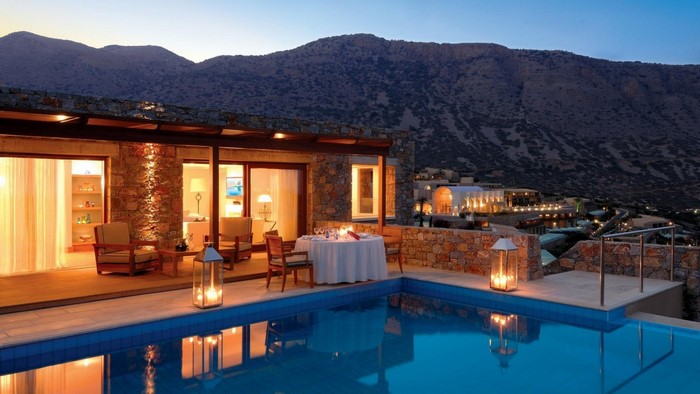 Luxury villa with swimming pool and mountain view at dusk