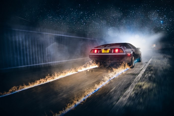 DeLorean car on fire driving at night