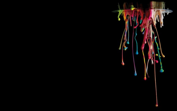 Colorful paint dripping from a surface