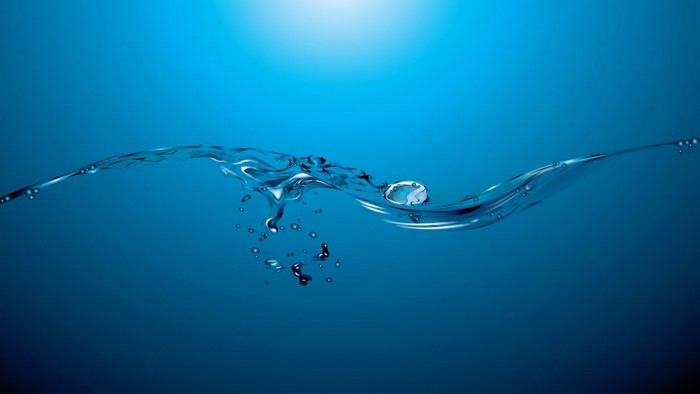 Abstract blue water surface with waves and bubbles