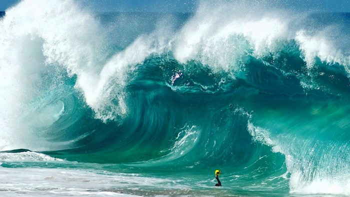 Huge Ocean Wave with Surfer in Water