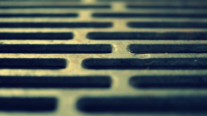 Close-up of a metal grate with a repeating pattern