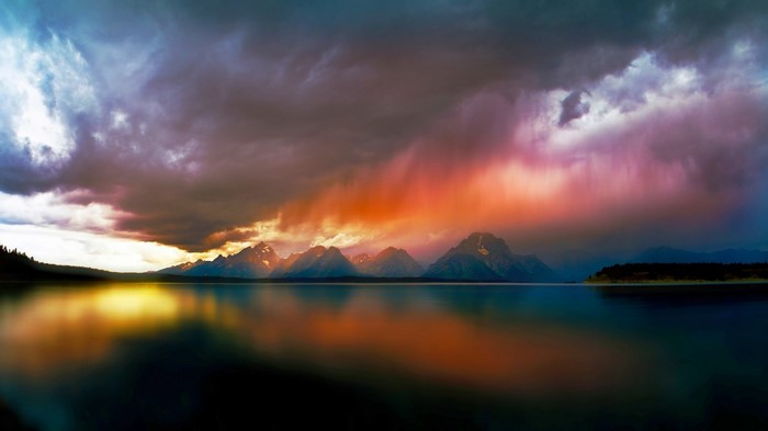Stormy Sunset Over Mountains Reflected in Lake