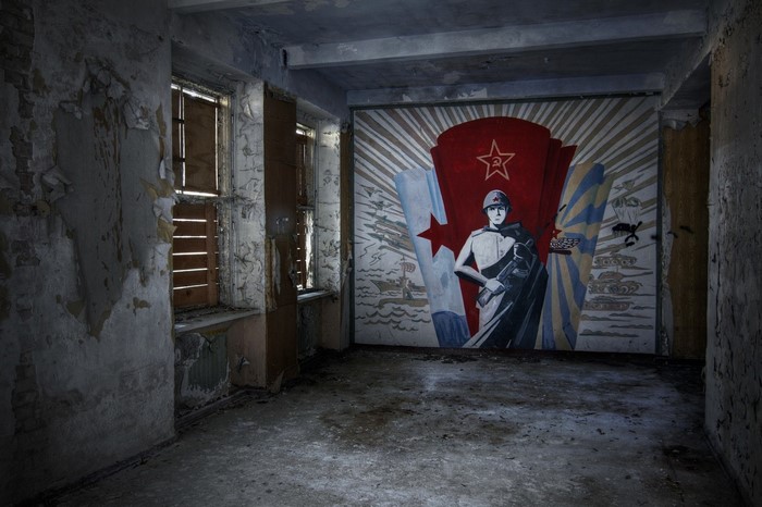 Abandoned room with Soviet propaganda mural
