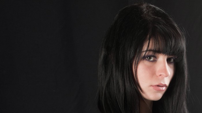 Woman with long black hair and bangs