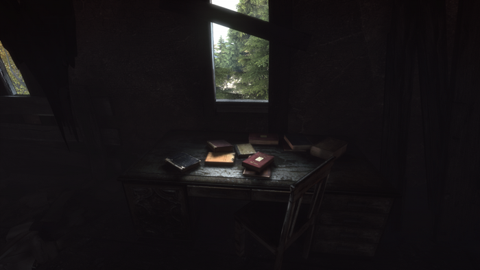 Desk with books in a dark room