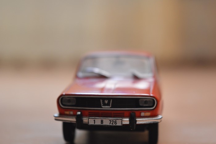 Red Dacia 1300 model car with license plate 1 B 726