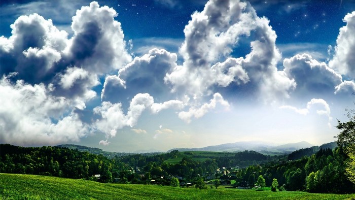 Panoramic landscape with rolling green hills and dramatic clouds