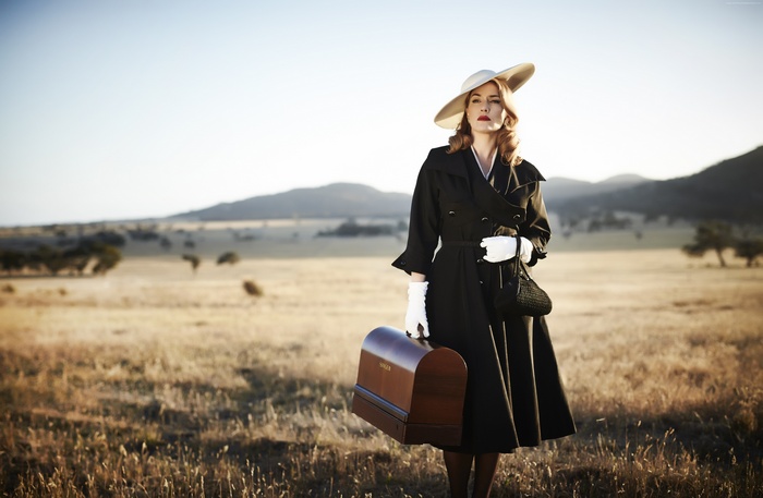 Kate Winslet in a field with a Singer sewing machine