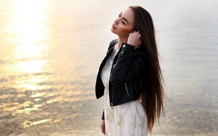 Woman with Long Hair in Leather Jacket by Water