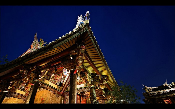 Ornate Chinese temple roof at night