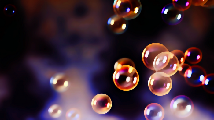 Bubbles with colorful reflections against a dark background
