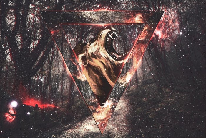 Roaring lion head in a triangle over a forest