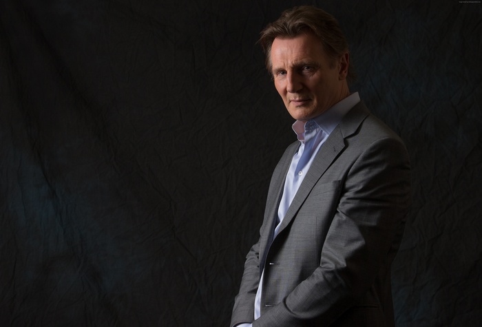 Liam Neeson in a grey suit