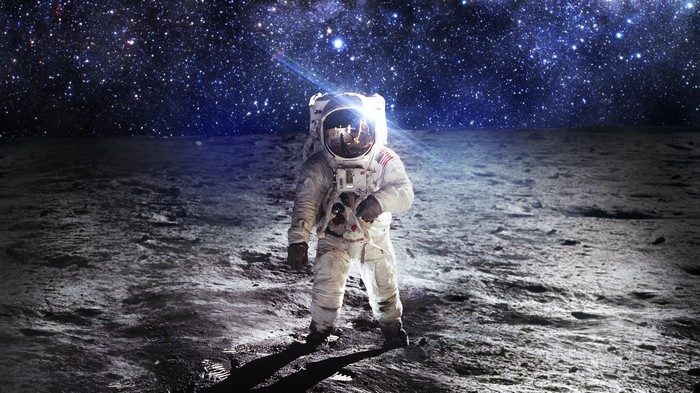 Astronaut on the moon under a starry sky