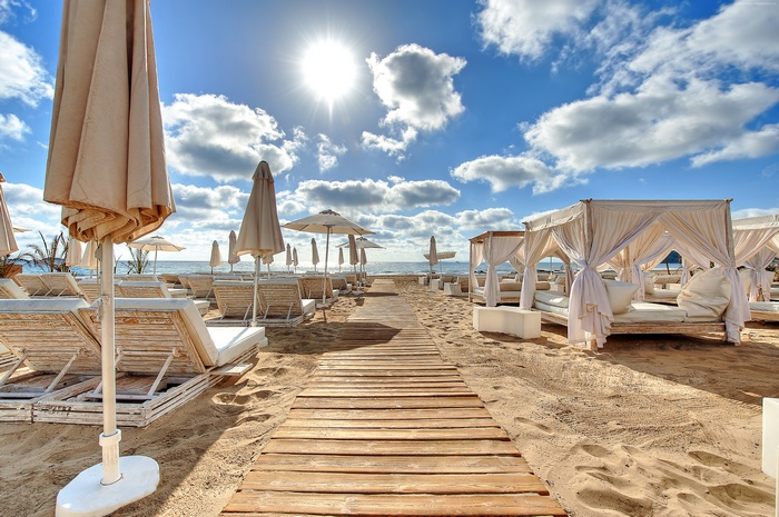 Beach with lounge chairs and cabanas