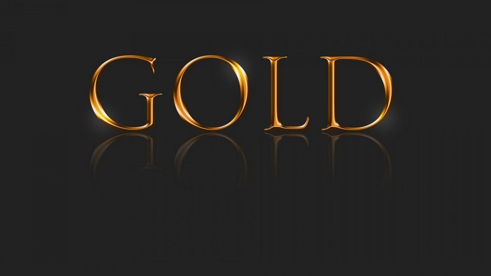 The word GOLD in golden metallic font with reflection