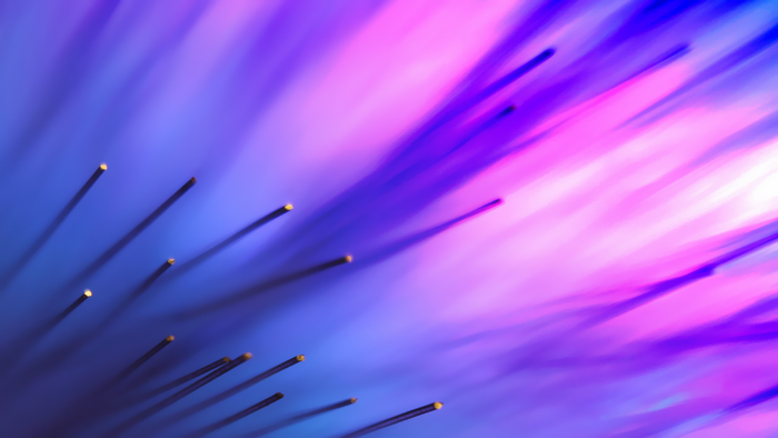 Close up of optic fibers with purple and blue light