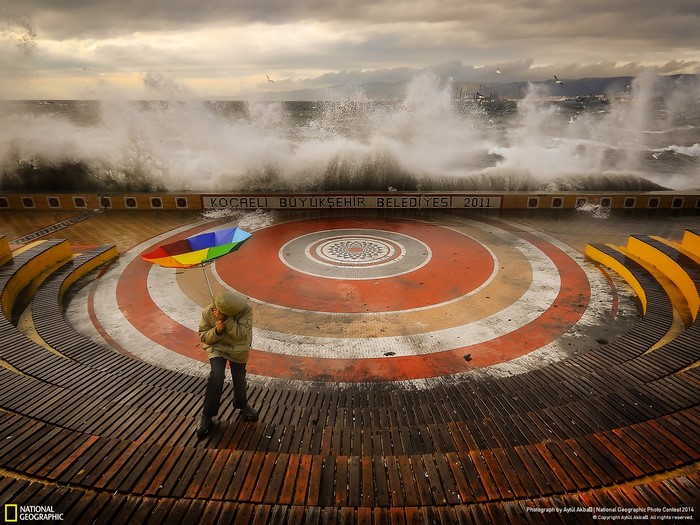 Person with umbrella in storm at Kocaeli Municipality amphitheater
