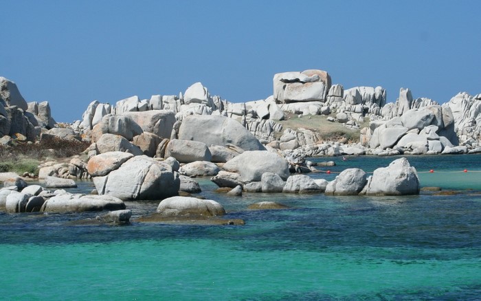 Rocky coast with turquoise water under a clear blue sky