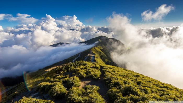 Mountain ridge with clouds and blue sky
