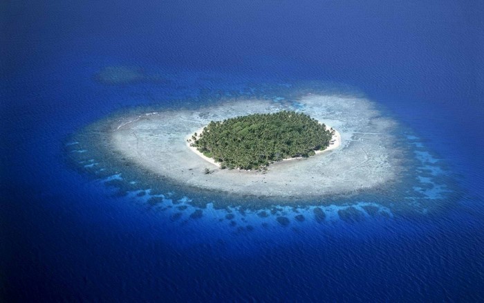 Aerial view of a tropical island atoll in the ocean