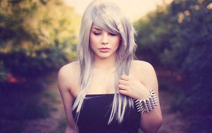 Woman with silver hair and spiked bracelet