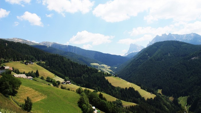 Green valley with mountains and scattered houses