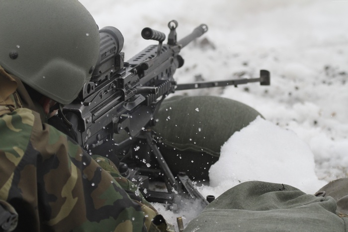Soldier firing M60 machine gun in the snow