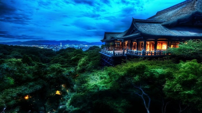 Japanese temple overlooking a city at night