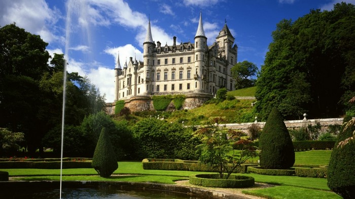 Dunrobin Castle with fountain and gardens in Scotland