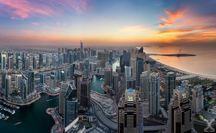 Dubai Marina cityscape at sunset with skyscrapers and ocean