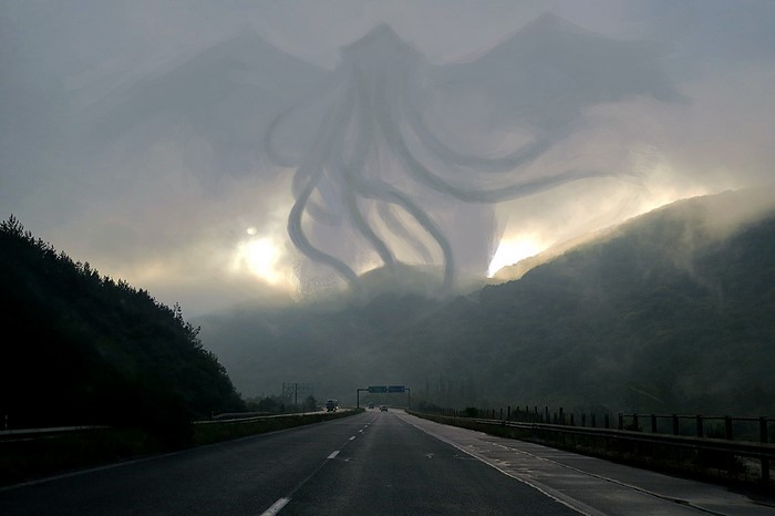 Giant Cthulhu-like creature in the clouds over a highway