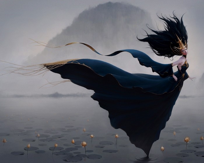 Woman in dark dress with flowing hair over a pond