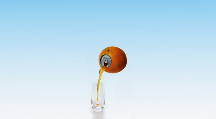 Creative Orange Can Pouring Juice Into Glass