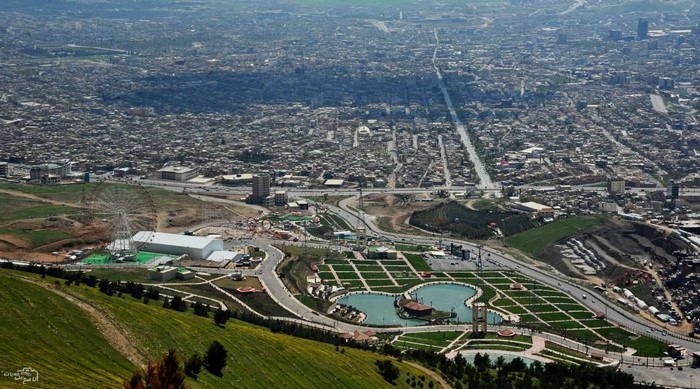 Aerial view of Slemani city with a park and Ferris wheel