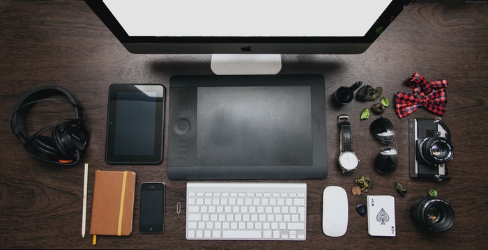 Desk setup with iMac, Wacom tablet, and accessories