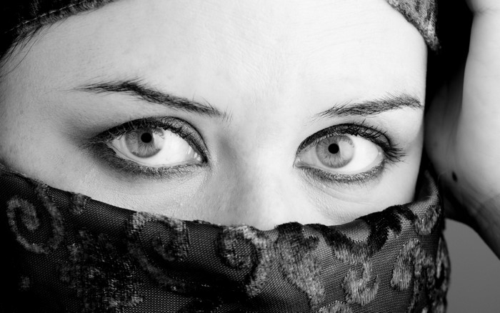 Monochrome portrait of a woman's eyes and veil