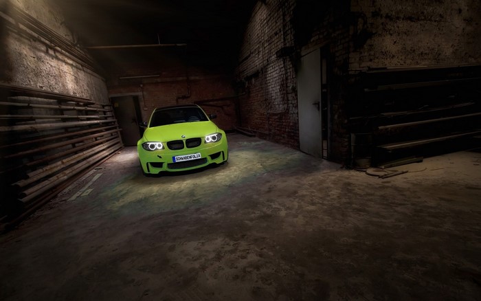 Green BMW E82 in a dark garage